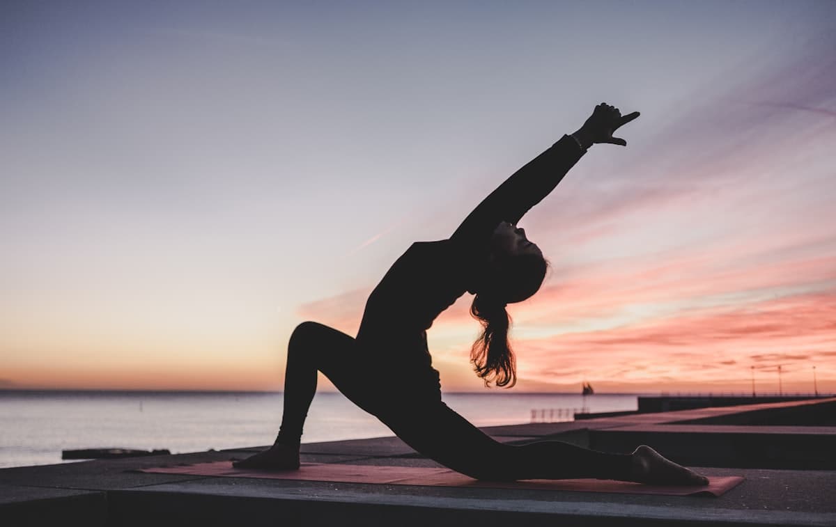 Yoga at sunset by the sea